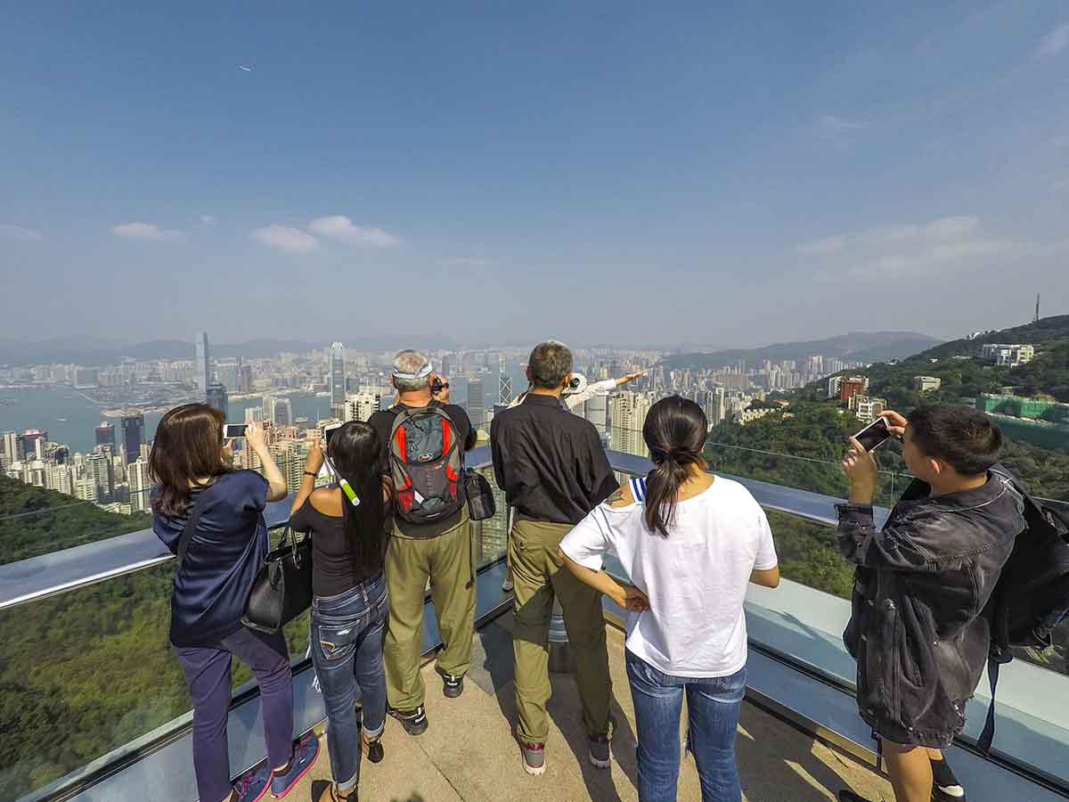 Taking pictures of the view from the top of Victoria peak in Hong Kong