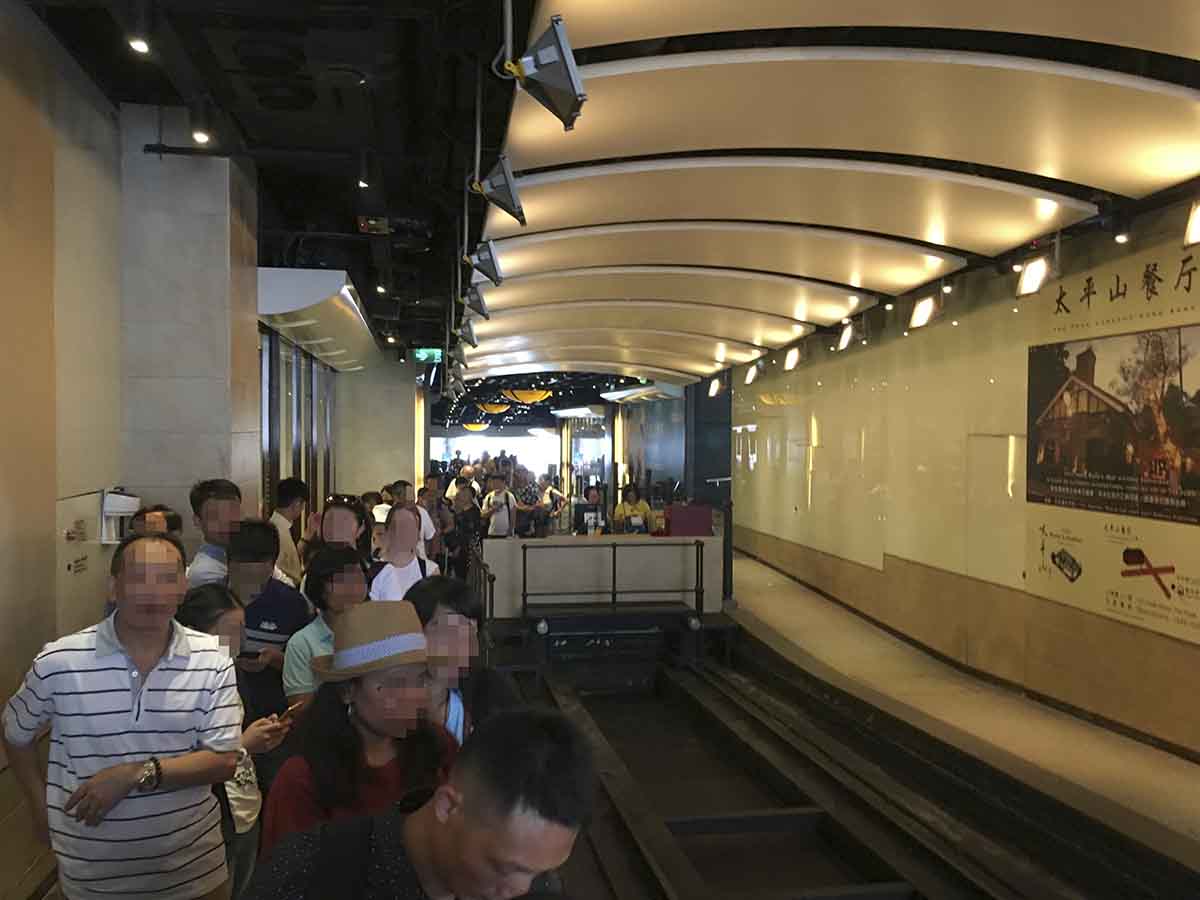 People waiting to board the tram up to Victoria peak in Hong Kong