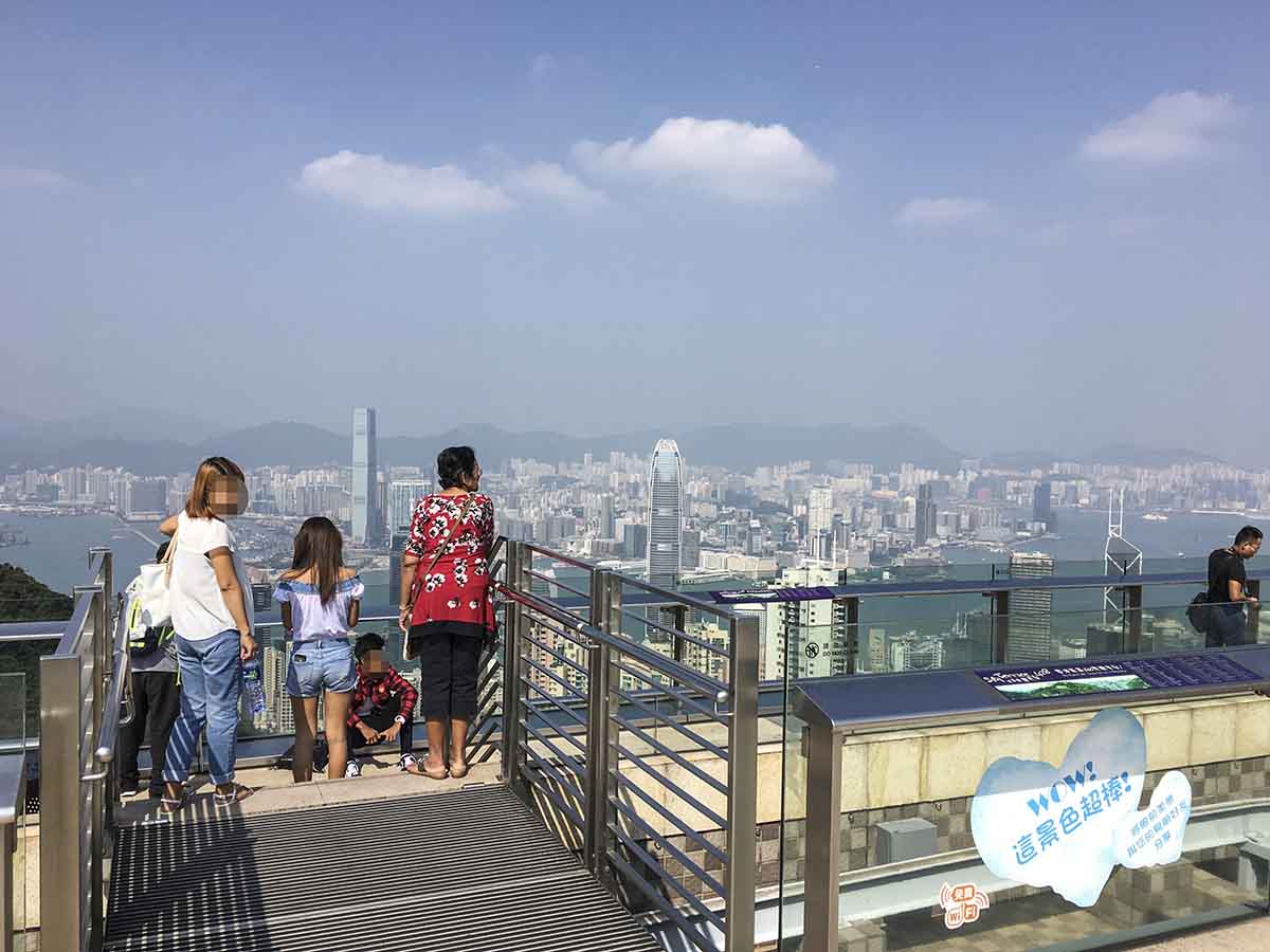 Tourists enjoying the view from Victoria peak in Hong Kong